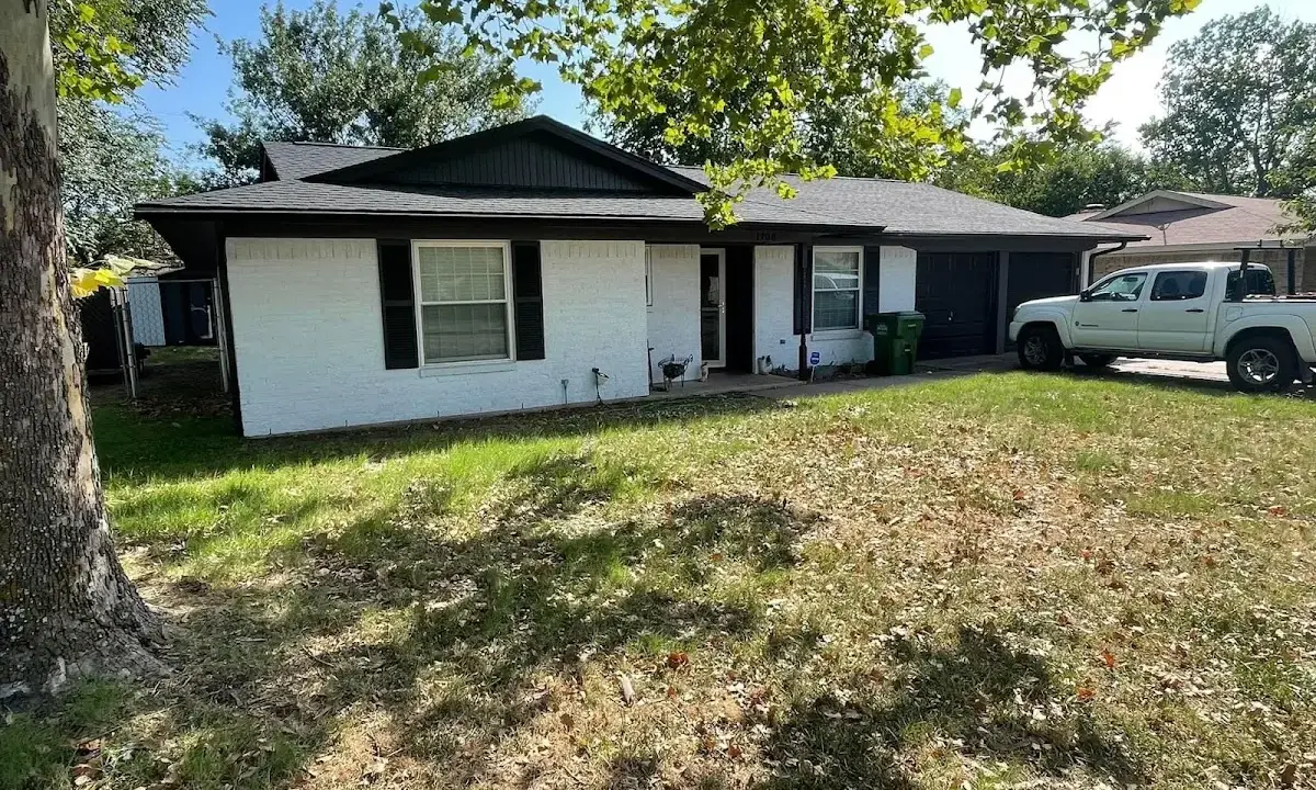 Professional roofing crew working on a residential roof in Brookline